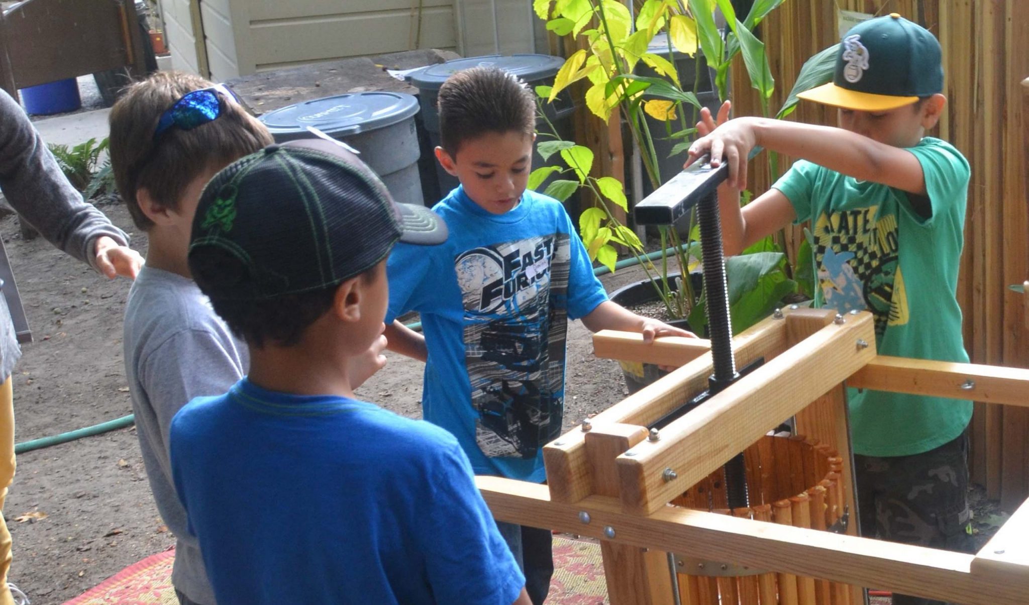 Children using the apple press